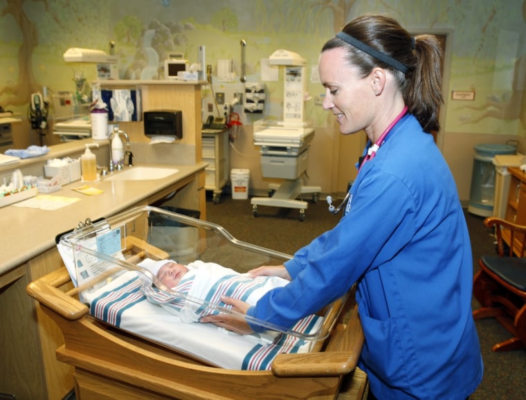 Image: Nurse Angie Hagen tends to a new born baby boy in the nursery at Denver Health medical facility in Denver