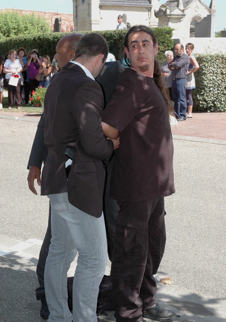 Image: A suspected aggressor against French President Nicolas Sarkozy is stopped by bodyguards