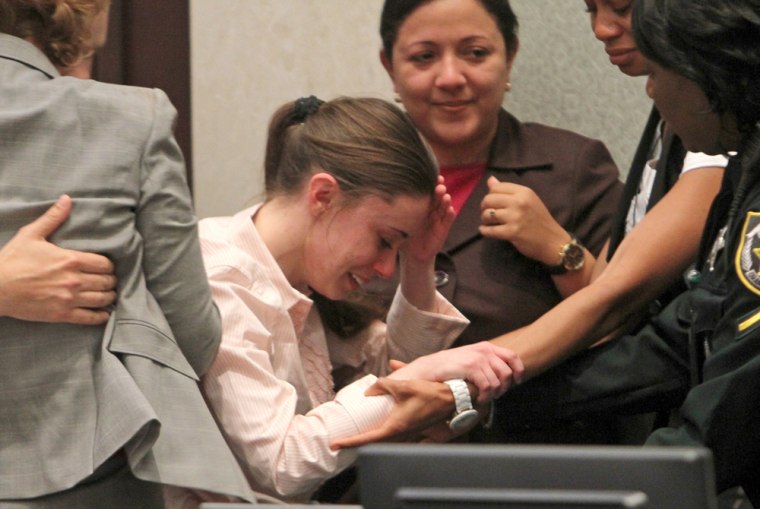 Image: Casey Anthony reacts with her defense team following her acquittal in Orlando