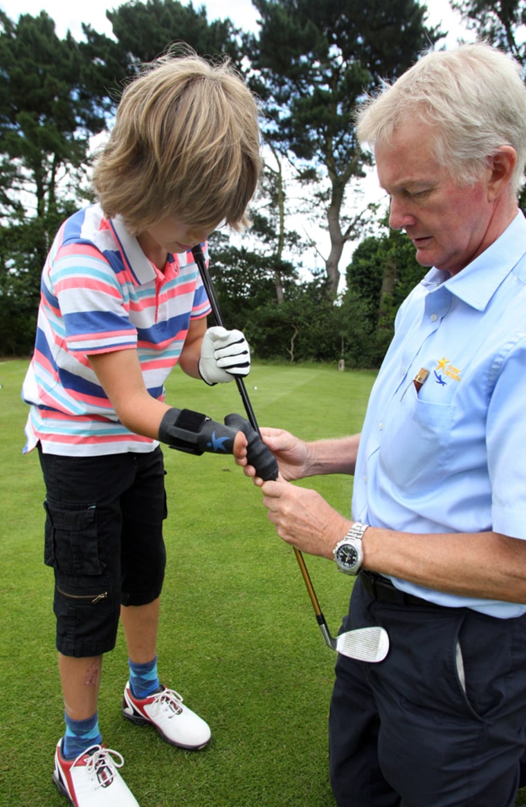 BNPS.co.uk (01202 558833)
Pic: Richard Crease/BNPS

Golfing prodigy Leo Millar(10) from Bournemouth is driving to the top - despite being born with only one hand. Thanks to a revolutionary new device Leo's handicap is coming down fast and his aim is to one day play in the Open alongside his golfing heroes. Professional's at his local club have been amazed by his natural swing and distance and are tipping him for a glittering career.
Bob Watts from Dorset Orthopaedic, the worlds leading creator of limbs for disabled sportsman has crafted a bespoke silicon 'glove' to help Leo achieve his ambitions.

Leo gets the glove fitted by Bob Watts from Dorset Orthopaedic.