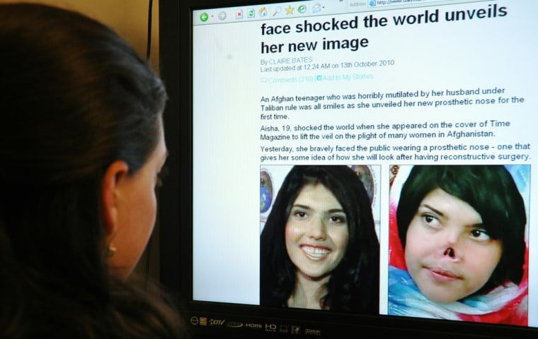 Image: A journalist reads an online story about