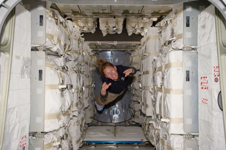 NASA astronaut Sandy Magnus flies through the Raffaello module, filled to the brim with supplies, during the final space shuttle mission to the space station.