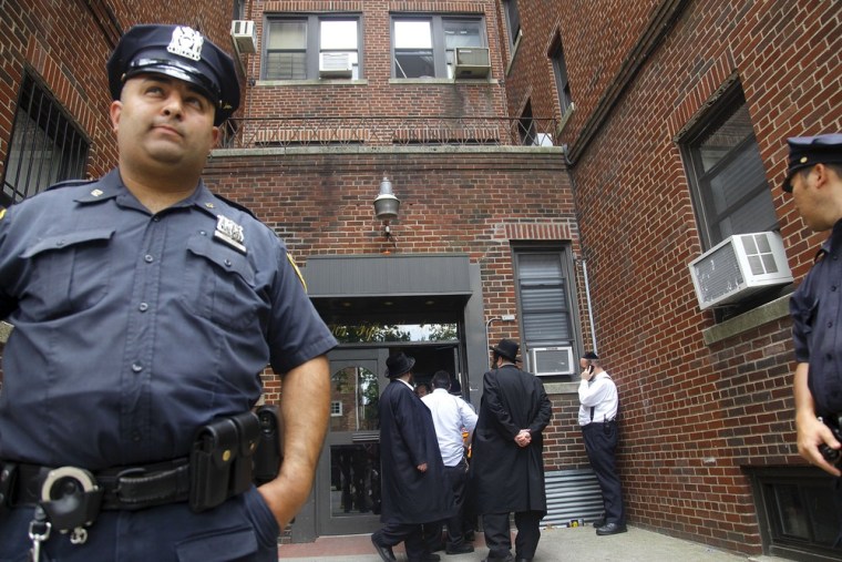 Image: Police at the entrance Leiby Kletzky's building in Brooklyn