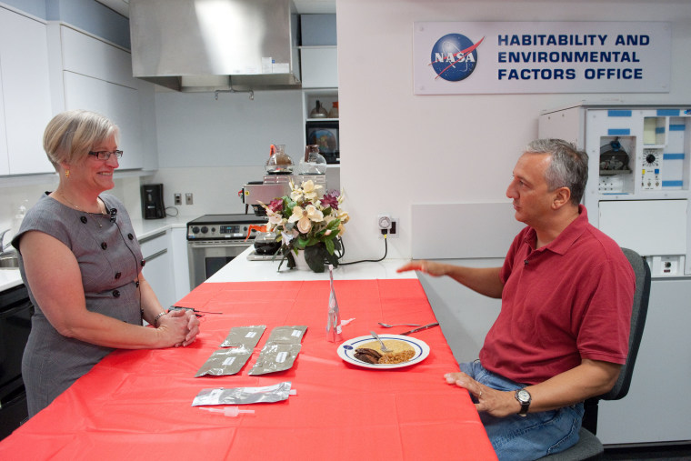 Vickie Kloeris, left, NASA food scientist and manager of the Space Food Systems Laboratory at the Johnson Space Center, and astronaut Mike Massimino discuss items on the "All-American Meal." They are in the Space Food Systems Laboratory. 