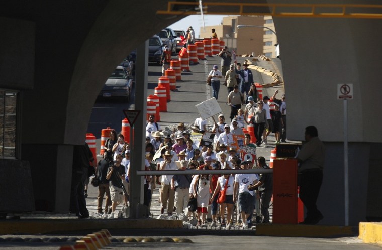 Image: Demonstrators from El Paso, Texas march over the Lerdo de Tejada international bridge, which connects Ciudad Juarez to El Paso, in support of the peace caravan led by Mexican poet Sicilia in Ciudad Juarez