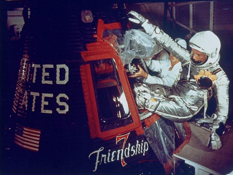 On Feb. 20, 1962, John Glenn rode the Friendship 7 capsule into space, the first time an American orbited the Earth. Here, technicians help Glenn enter the capsule.