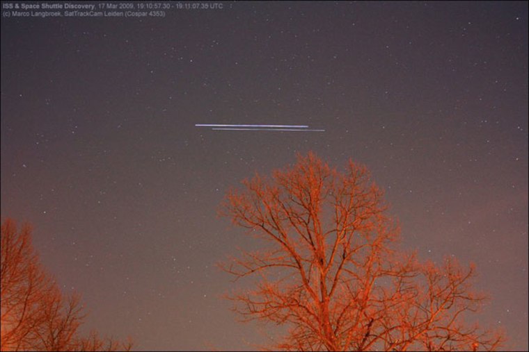 NASA's space shuttle Discovery and the International Space Station streak across the sky in this time-lapsed image, taken over Leiden, The Netherlands, just before the two spacecraft docked on March 17, 2009 during the STS-119 mission. The shuttle is the object slightly fainter and lower in the sky. Movement is from right to left.