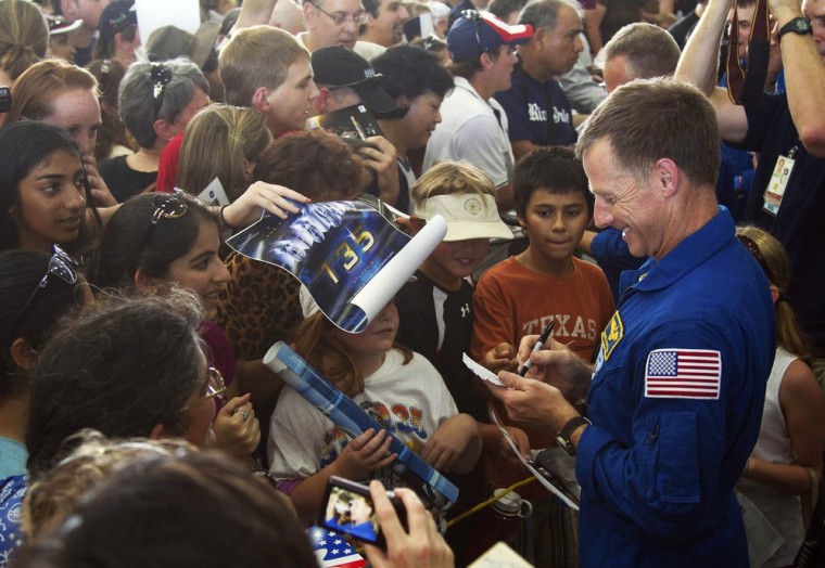Image: Space shuttle Atlantis Chris Ferguson signs autographs following a welcome home ceremony for the last shuttle crew.