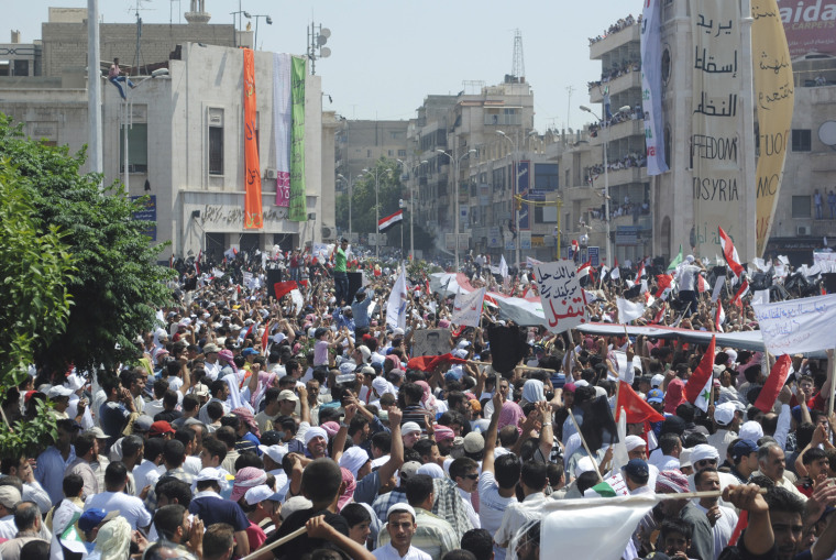 Image: People take part in a protest against President Bashar al-Assad after Friday prayers in Hama