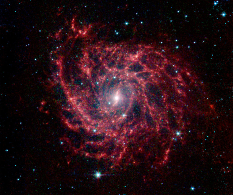 Spiral galaxy glows like a cosmic spider web