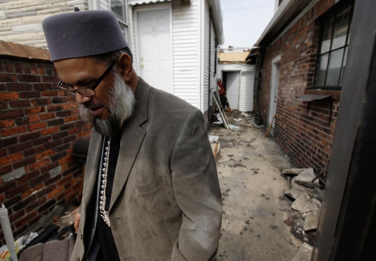 Image: Imam Abdul Latif Azom walks past damage from an April 1, 2011 fire at the Masjid Al-Falah Islamic Center of North Detroit in Detroit
