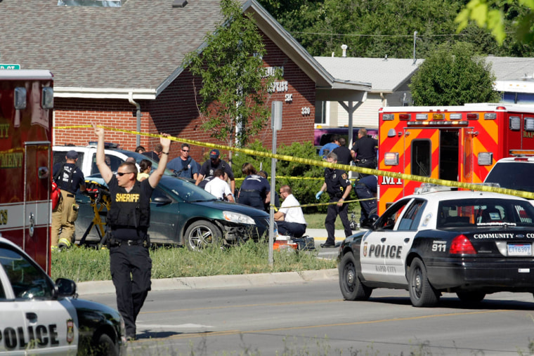 Image: Rapid City Firefighter/Paramedics and Rapid City Police Department personnel respond to shootings at the intersection of Anamosa and Greenbriar streets, in Rapid City, S.D.