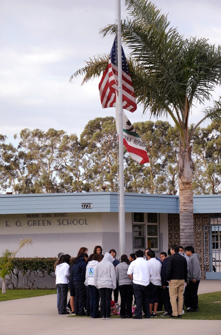 Students gather around a makeshift memorial at E.O. Green middle school, honoring slain school student Lawrence King, 15, who was killed by a classmate because he was gay.
