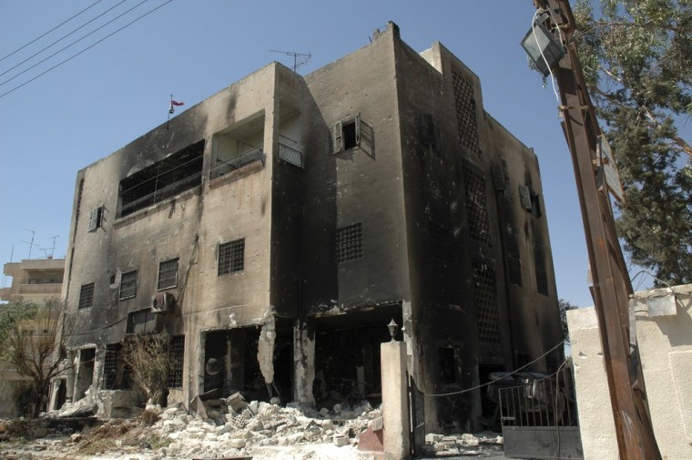 Image: A damaged police station is seen in Hama, Syria