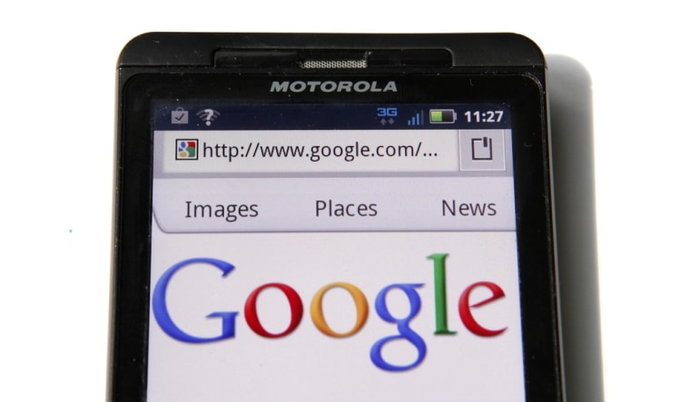 Image: A Google homepage is displayed on a Motorola Droid phone in Washington