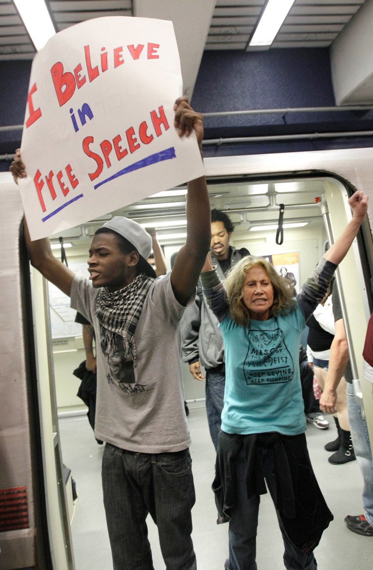 Image: Jevon Cochran, left, and protesters stand in the door of a BART train at the Civic Center station in San Francisco