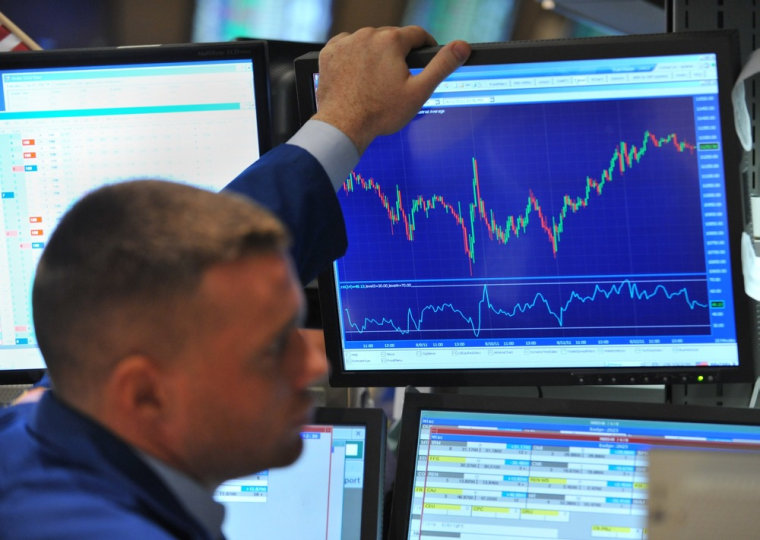 Image: Frank Masiello looks at a display showing the ups and downs of Dow Jones Industrial Average during the past week