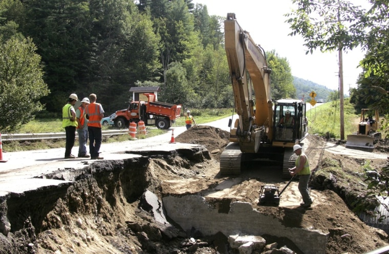 Image: Vermont Transportation Agency workers repair a section of a road in Waitsfield