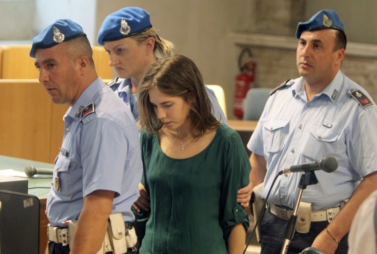 Image: Amanda Knox, the U.S. student convicted of killing her British flatmate Meredith Kercher in Italy on November 2007, leaves the courtroom in Perugia