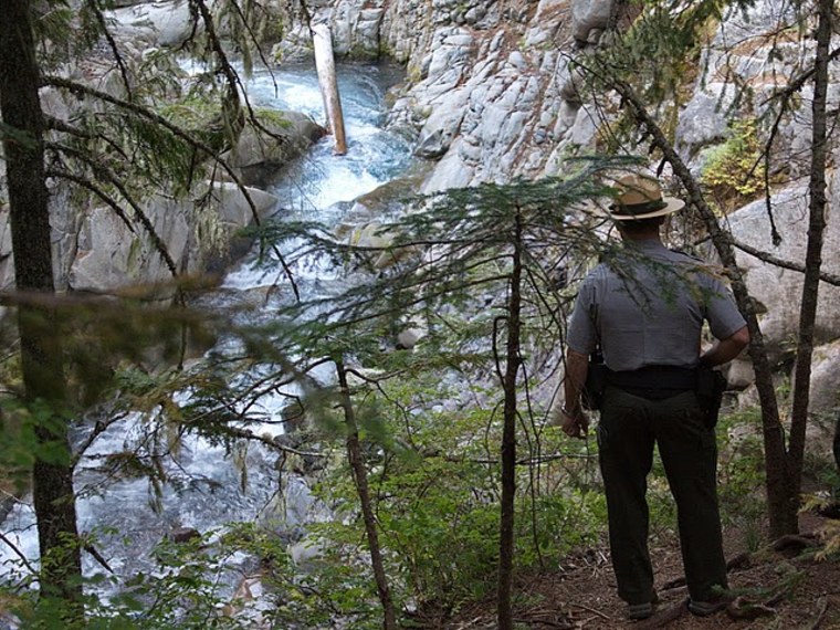Image: Ranger at site of falls where visitor died