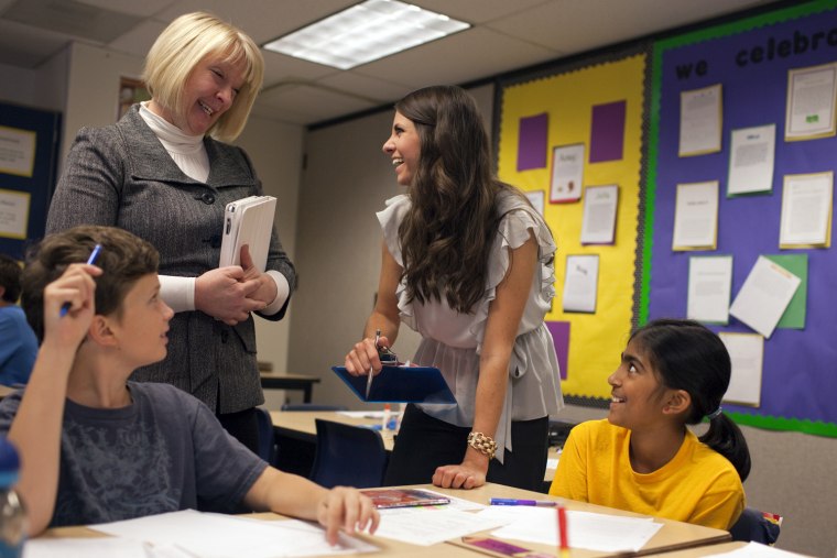 Cim Dew, left, works with 6th grade teacher Amy Esmay at Redmond Elementary School, Redmond, Wash., Sept. 14, 2011. Dew, a retired teacher, is part of the school districtÕs New Teacher Support Program, where experienced teachers help first-year teachers like Esmay through mentoring and instructional coaching.