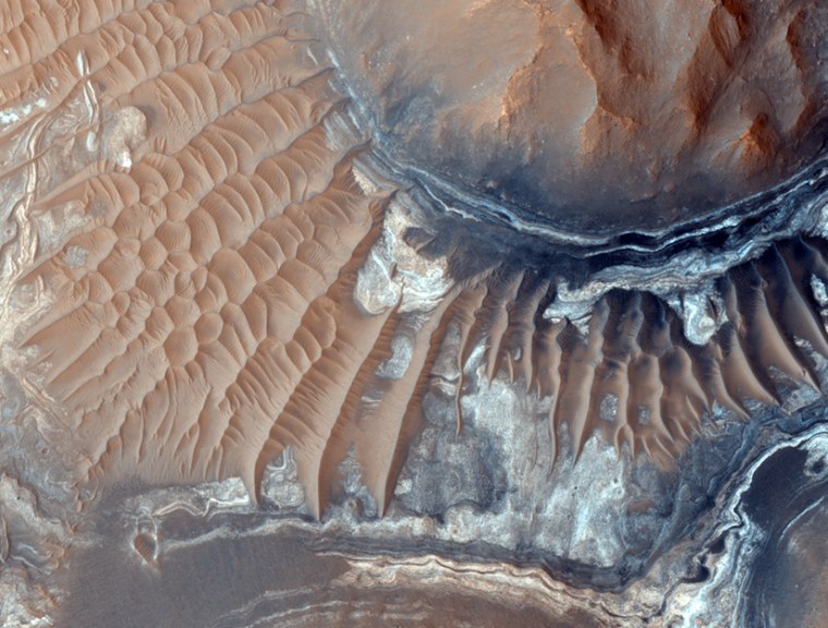 Exposed layers are seen in the Martian trench system, Noctis Labyrinthus, which may contain water-bearing deposits of clay minerals and could have once been host to life.