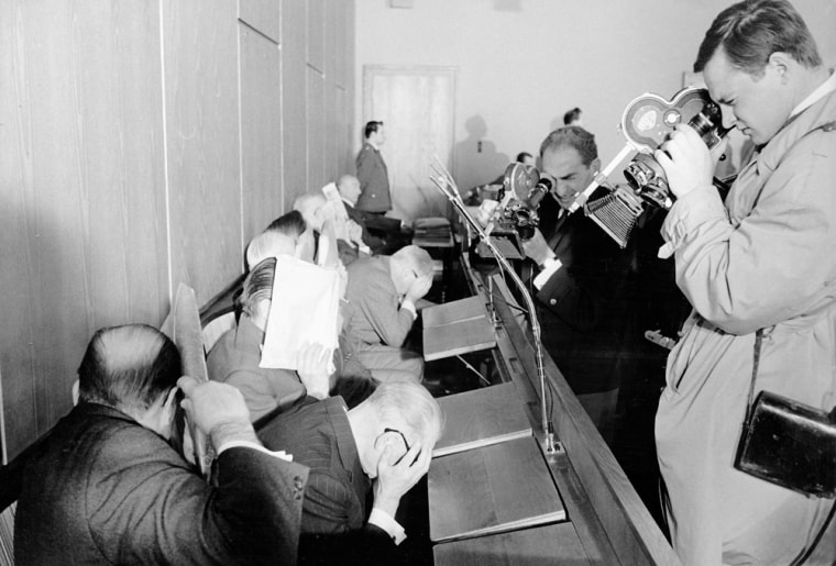 Accused former Nazi functionaries of the Treblinka death camp try to hide their faces at the beginning of the Treblinka trial in Dusseldorf, western Germany, Oct. 12, 1964.