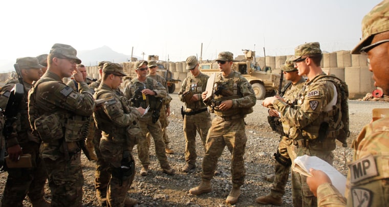Image: U.S. soldier SSG Brandon Shaffer from 127th Military Police Task Force \"Cacti\" conducts platoon briefing before going for a mission in Combat Outpost Penich