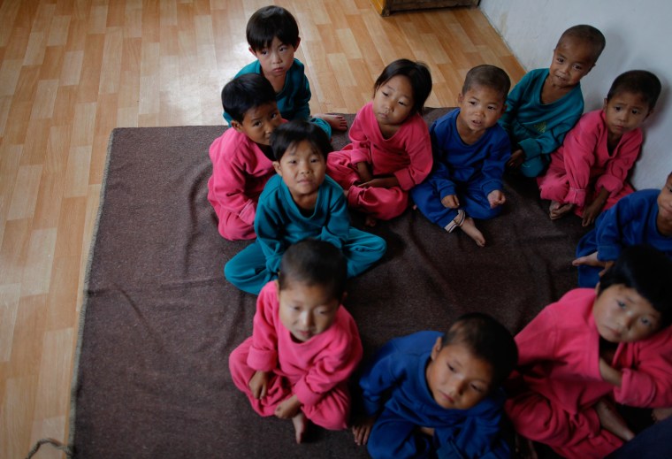 Image: North Korean orphans suffering from waterborne diseases wait to be examined for possible signs of malnutrition in South Hwanghae province