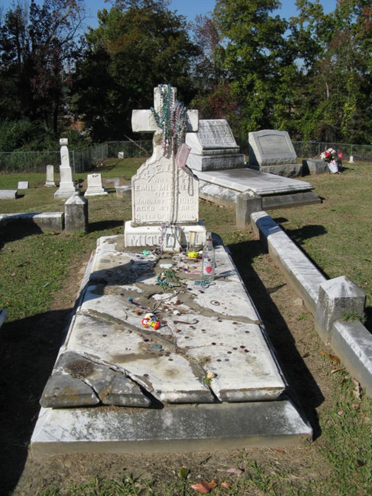 The grave of the gypsy queen Kelly Mitchell, where her visitors leave gifts. Botanists think her followers may also have introduced a foreign plant, called blue sedge, to Mississippi.