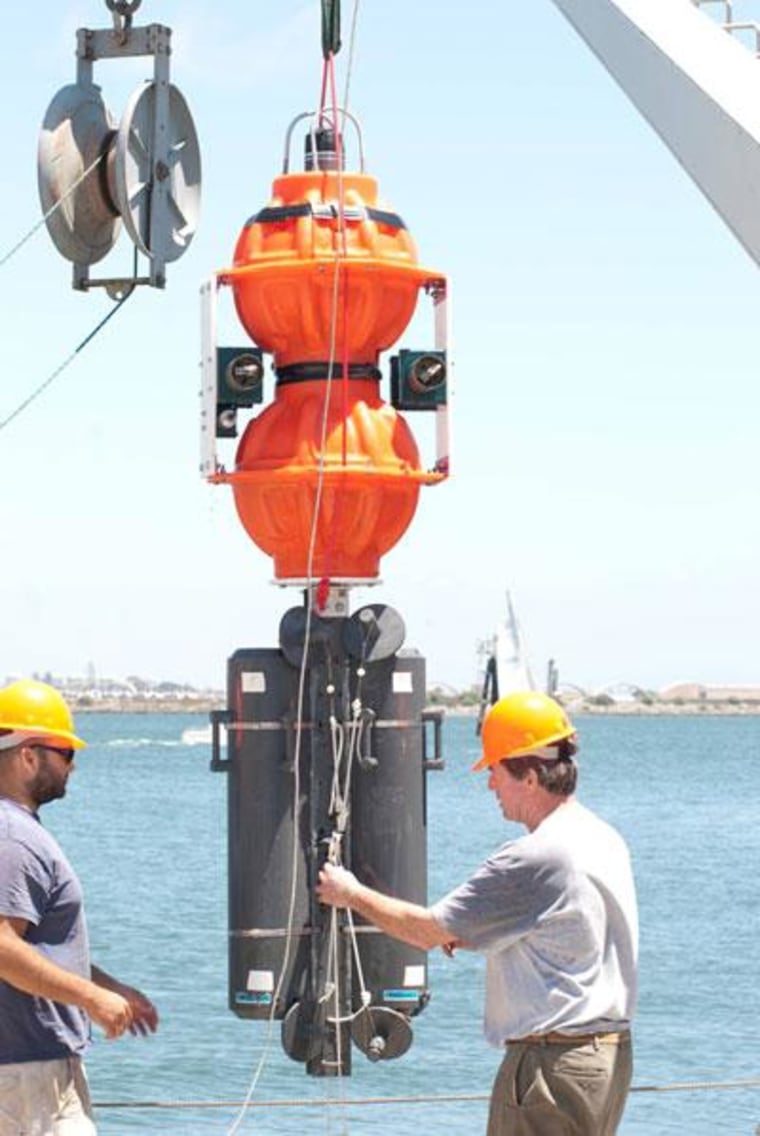 Scripps ocean engineer Kevin Hardy (right) and marine technician Josh Manger prepare to test Hardy's deep-sea lander at Scripps' Nimitz Marine Facility.