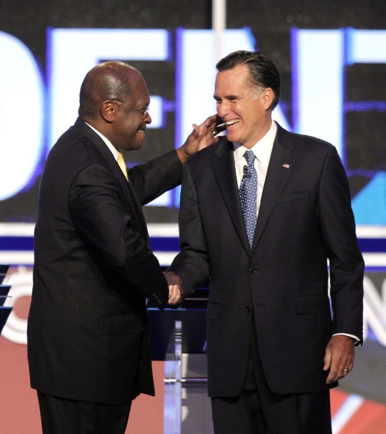 Image: Herman Cain greets Mitt Romney before a Republican presidential debate Tuesday.