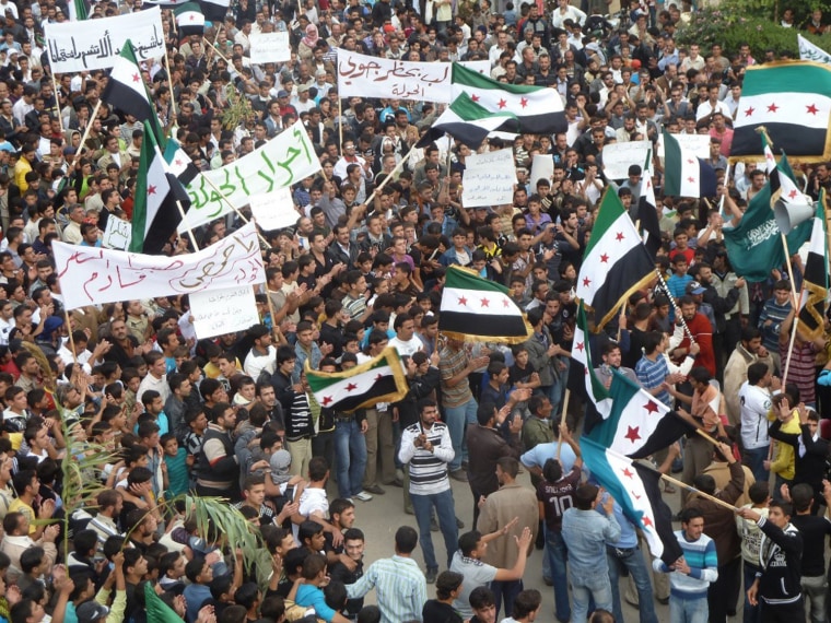 Image: Demonstrators protesting against Syria's President Bashar al-Assad march through the streets after Friday prayers in Hula