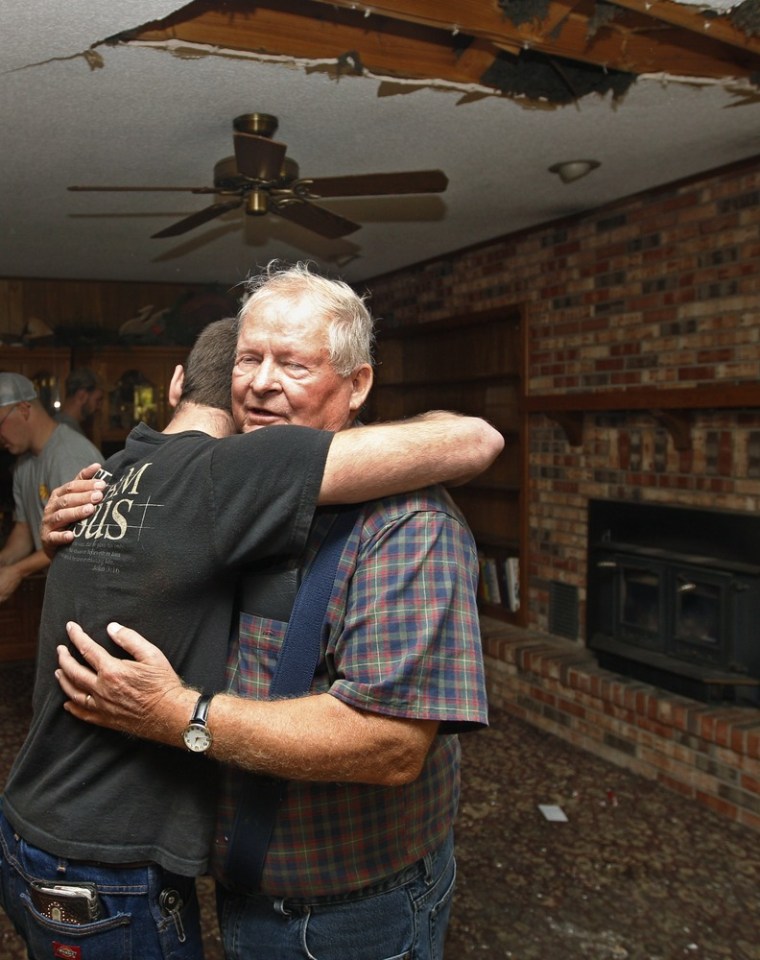 Image: Joe Reneau and Cody Parsons embrace amidst earthquake damage in Oklahoma