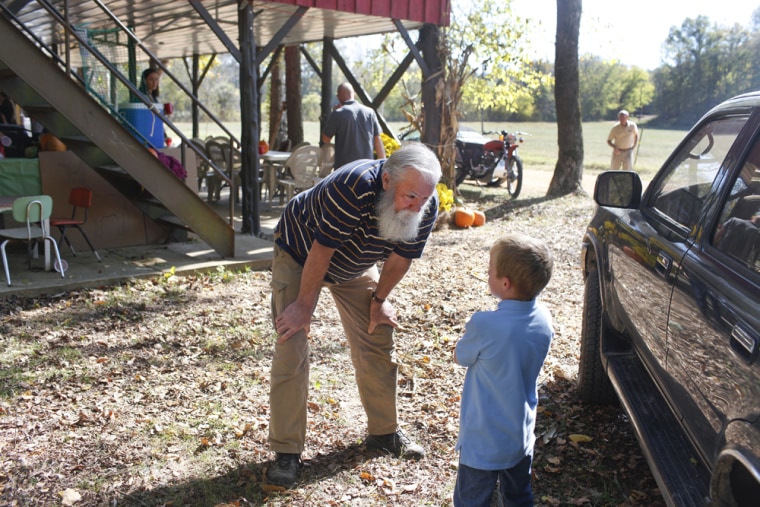 Image: Michael Pearl talks with a boy at Cane Creek Church.