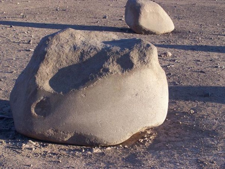 Midsections of huge boulders in Chile's Atacama Desert appear to be rubbed smooth.