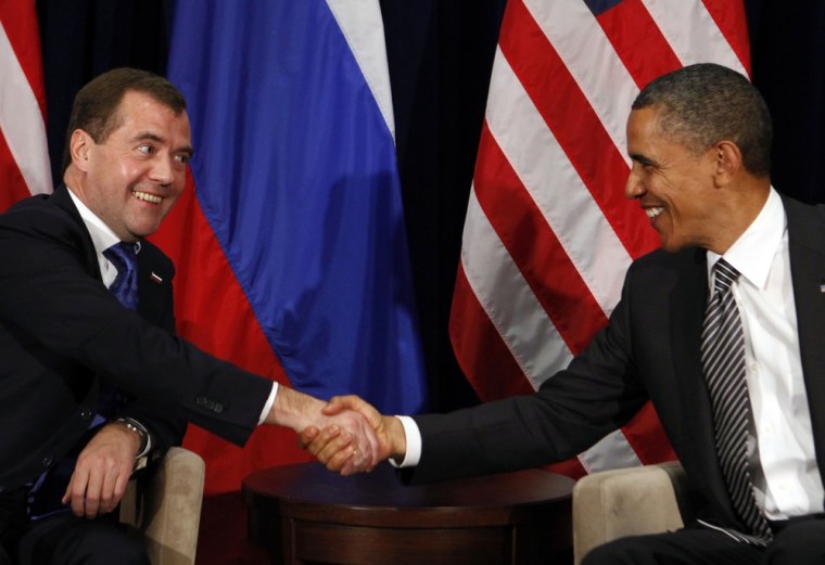 Image: U.S. President Obama shakes hands with Russian President Medvedev during APEC Summit in Hawaii