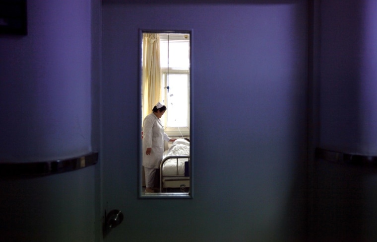 Image: A nurse talks to an infected patient in the HIV/AIDS ward of Beijing YouAn Hospital