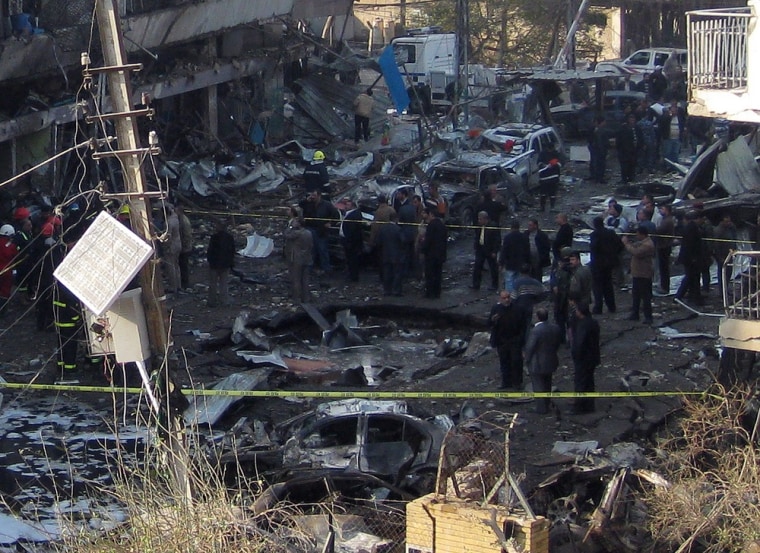 Image: Iraqi security forces inspect a crater caused by a car bomb attack in the neighborhood of Karrada in Baghdad, Iraq.