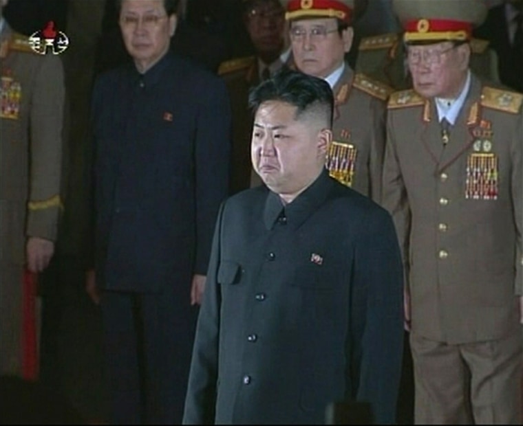 Image: New North Korean ruler Kim Jong-un pays his respects to his father and former leader Kim Jong-il, lying in state at the Kumsusan Memorial Palace in Pyongyang