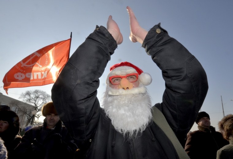 Image: An activist wearing a Santa Claus mask at protest in Vladivostok, Russia