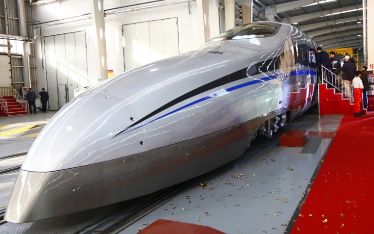 Image: Visitors board a new testing model of a CSR high-speed bullet train during its launching ceremony in Qingdao