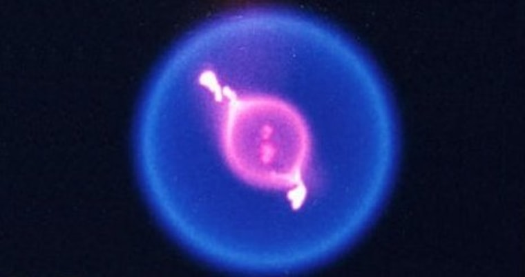 A color image of a fuel droplet burning in space during NASA's Flame Extinguishment Experiment aboard the International Space Station.