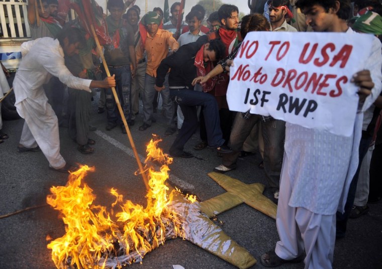 Image: Protesters burn a replica drone during a rally in Islamabad on Oct. 28