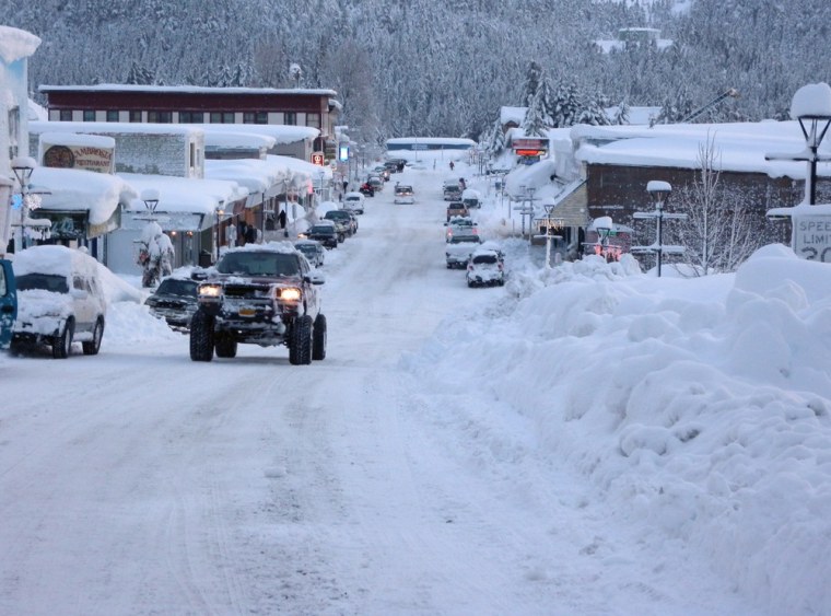 Image: Vehicles move down snow-covered streets in the fishing town of Cordova, Alaska