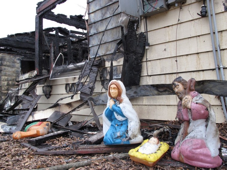 Image: Soot covers charred Christmas decorations outside the home of Janice Robbins near Conway, Ark.