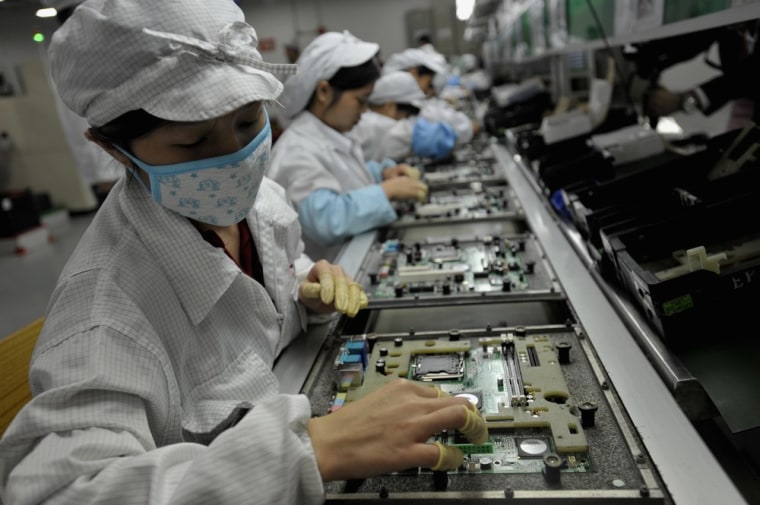 Image: Chinese workers assemble electronic components at the Taiwanese technology giant Foxconn's factory in Shenzhen