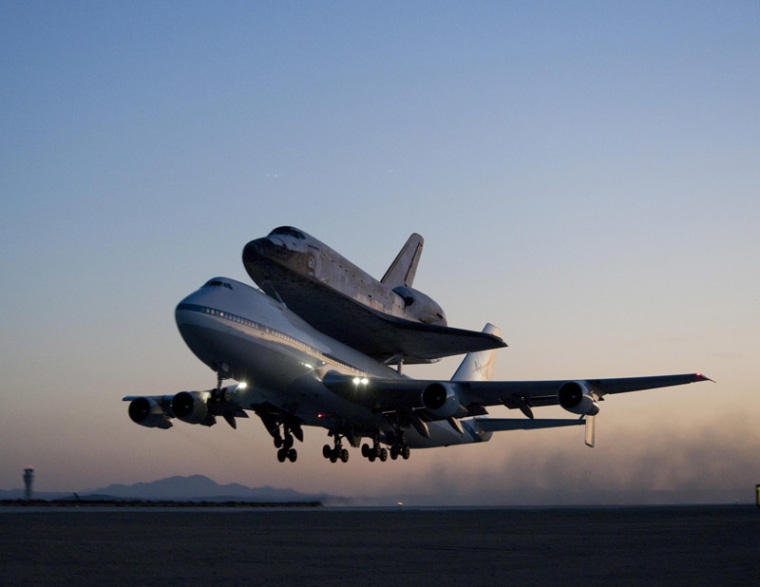 Space shuttle Discovery and its modified 747 carrier aircraft lift off from Edwards Air Force Base early in the morning of Sept. 20, 2009 on the first leg of its ferry flight back to the Kennedy Space Center in Florida.