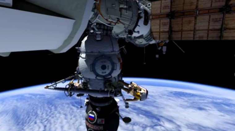 This still from a NASA animation shows how Russian cosmonauts Oleg Kononenko and Anton Shkaplerov may use one crane to move another outside the International Space Station during a spacewalk on Thursday.