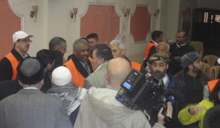 Image: Arab League observers talk to people during a visit to Zabadani